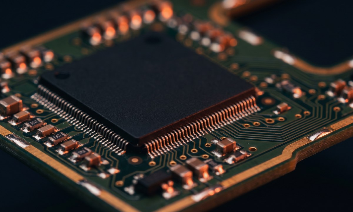 Microchip and PCB macro photograph — silicon at scale